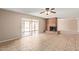Spacious living room with brick fireplace, tile floors and access to the backyard patio at 1874 E Huntington Dr, Tempe, AZ 85282