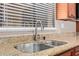 The kitchen features a stainless steel sink with a chrome faucet and granite countertops at 1874 E Huntington Dr, Tempe, AZ 85282
