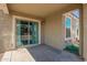 Covered back patio featuring a sliding glass door and outdoor lighting, perfect for relaxing or entertaining at 19951 W Wilson St, Buckeye, AZ 85326