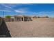 Large backyard showcasing a covered patio, rock ground cover, block wall, and inviting outdoor space at 19951 W Wilson St, Buckeye, AZ 85326
