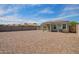 View of the backyard featuring rock ground cover, a covered patio, and block wall fencing at 19951 W Wilson St, Buckeye, AZ 85326
