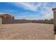 Spacious backyard featuring a rock ground cover, block fence, and string lights creating an inviting outdoor space at 19951 W Wilson St, Buckeye, AZ 85326