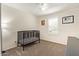 Bedroom featuring a crib, a large window, carpeted floors, and natural light at 19951 W Wilson St, Buckeye, AZ 85326