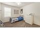 Well-lit bedroom featuring a large window, toy decor, carpeted floors and ceiling fan at 19951 W Wilson St, Buckeye, AZ 85326