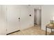 Bright entryway with tiled floor, a white front door, and views into the home at 19951 W Wilson St, Buckeye, AZ 85326