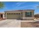 Charming single-story home with a two-car garage and neutral stucco exterior, complemented by desert landscaping at 19951 W Wilson St, Buckeye, AZ 85326