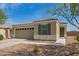 Charming single-story home with a two-car garage and neutral stucco exterior, complemented by desert landscaping at 19951 W Wilson St, Buckeye, AZ 85326