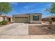 Charming single-story home with a two-car garage and neutral stucco exterior, complemented by desert landscaping at 19951 W Wilson St, Buckeye, AZ 85326