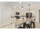 Updated kitchen with white cabinets, granite countertops, stainless steel appliances, and pendant lighting at 19951 W Wilson St, Buckeye, AZ 85326