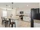 Modern kitchen with white cabinets, granite countertops, a black refrigerator, and stainless steel appliances at 19951 W Wilson St, Buckeye, AZ 85326