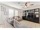 Comfortable living area with large television, built-in shelving, and neutral-toned furnishings at 19951 W Wilson St, Buckeye, AZ 85326