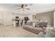 Open-concept living area with kitchen, couch, tile flooring, ceiling fan, and recessed lighting at 19951 W Wilson St, Buckeye, AZ 85326
