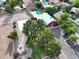 A vibrant aerial view of a community with a pool, a barn, and a horse arena at 20439 E Palomino Dr, Queen Creek, AZ 85142