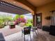 Inviting backyard featuring a covered patio, comfortable seating, and desert landscaping at 20439 E Palomino Dr, Queen Creek, AZ 85142