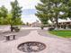 Scenic backyard featuring a brick fire pit, garden, and a glimpse of a basketball court and home at 20439 E Palomino Dr, Queen Creek, AZ 85142