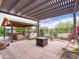Beautiful backyard with covered patio, outdoor kitchen, and lush landscaping at 20439 E Palomino Dr, Queen Creek, AZ 85142