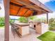Awesome outdoor kitchen with ample seating, TV, and stainless steel grill at 20439 E Palomino Dr, Queen Creek, AZ 85142