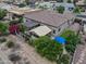 A view of the backyard showing the covered patio, lush landscaping, privacy fence, and easy access to the home at 20439 E Palomino Dr, Queen Creek, AZ 85142