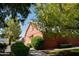 Rustic barn featuring wood construction, a gable roof, and lush landscaping, perfect for equestrian use at 20439 E Palomino Dr, Queen Creek, AZ 85142