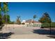 Spacious basketball court beside a home with palm trees, offering a perfect blend of recreation and luxury at 20439 E Palomino Dr, Queen Creek, AZ 85142