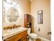 Charming powder room featuring a decorative mirror, granite counters and wooden cabinet at 20439 E Palomino Dr, Queen Creek, AZ 85142
