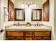 Double vanity in bathroom with matching mirrors and cabinet space at 20439 E Palomino Dr, Queen Creek, AZ 85142