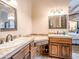 Spacious bathroom featuring dual sinks, custom cabinets, and views into bedroom at 20439 E Palomino Dr, Queen Creek, AZ 85142