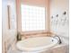 Serene bathroom featuring a soaking tub, natural light, and stylish tile accents at 20439 E Palomino Dr, Queen Creek, AZ 85142