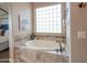 Relaxing bathroom features a soaking tub, natural light, and stylish tile accents at 20439 E Palomino Dr, Queen Creek, AZ 85142