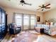 Spacious main bedroom featuring a ceiling fan, windows, and hardwood floors at 20439 E Palomino Dr, Queen Creek, AZ 85142