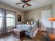 Comfortable bedroom featuring a ceiling fan, bed and a window at 20439 E Palomino Dr, Queen Creek, AZ 85142