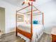 Bright bedroom featuring a canopy bed, ceiling fan, and wood-look floors at 20439 E Palomino Dr, Queen Creek, AZ 85142
