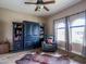 Cozy bedroom featuring hardwood floors, a recliner, and plenty of windows at 20439 E Palomino Dr, Queen Creek, AZ 85142