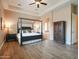 Bright bedroom featuring a ceiling fan, a canopy bed and an attached bathroom at 20439 E Palomino Dr, Queen Creek, AZ 85142