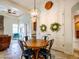 Dining area with wooden table and black chairs, with view into living room at 20439 E Palomino Dr, Queen Creek, AZ 85142