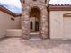 Close-up of the unique stone tower entrance leading into the home's arched doorway at 20439 E Palomino Dr, Queen Creek, AZ 85142