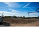 Equestrian arena with good dirt, and covered stalls with mountain views in the background at 20439 E Palomino Dr, Queen Creek, AZ 85142