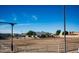 Clean equestrian arena with good dirt and stall facility with mountain views in the background at 20439 E Palomino Dr, Queen Creek, AZ 85142