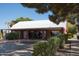 Charming exterior of a ranch-style building, highlighting the red brick and tin roof for a unique look at 20439 E Palomino Dr, Queen Creek, AZ 85142