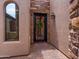 Elegant front door with decorative ironwork, a welcome mat, and classic outdoor lighting at 20439 E Palomino Dr, Queen Creek, AZ 85142