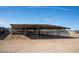 View of horse facilities on a sunny day showing metal roofing and fencing at 20439 E Palomino Dr, Queen Creek, AZ 85142