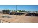 This property includes covered horse stalls and other equestrian amenities on a sunny day at 20439 E Palomino Dr, Queen Creek, AZ 85142