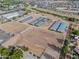 Aerial shot of a horse property featuring stables, arenas, and an adjacent neighborhood at 20439 E Palomino Dr, Queen Creek, AZ 85142