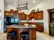 Kitchen island with fruit, cabinets with horse statue, appliances and countertops at 20439 E Palomino Dr, Queen Creek, AZ 85142