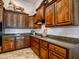 Beautiful kitchen with custom wooden cabinets, stone countertops, and stainless steel appliances at 20439 E Palomino Dr, Queen Creek, AZ 85142