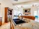 Kitchen island with granite countertop and black sink, leading to the living room at 20439 E Palomino Dr, Queen Creek, AZ 85142