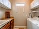 Functional laundry room with ample storage, sink, countertop, and washer/dryer at 20439 E Palomino Dr, Queen Creek, AZ 85142