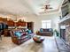 Open floor plan with kitchen and living room, showcasing leather couches and stone fireplace at 20439 E Palomino Dr, Queen Creek, AZ 85142