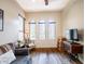 Bright and airy living room featuring hardwood floors, three windows and nice furniture at 20439 E Palomino Dr, Queen Creek, AZ 85142