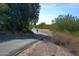 Smooth asphalt neighborhood path with trees, bushes, and a bicyclist in Queen Creek, AZ at 20439 E Palomino Dr, Queen Creek, AZ 85142